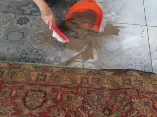 Dusting a rug